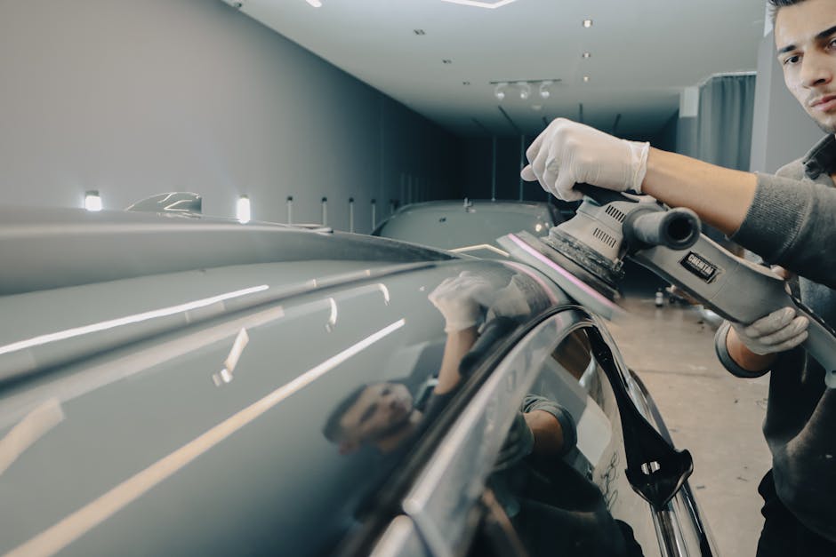 Professional auto detailer working on a vehicle's exterior